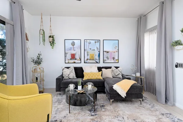 a living room with furniture and painting on the wall