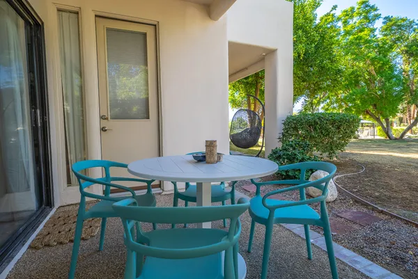 a view of a patio with table and chairs