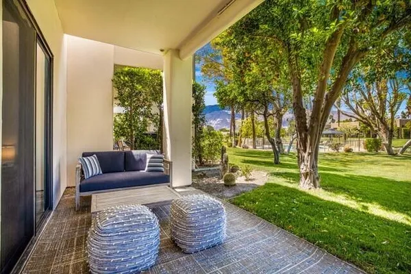 a backyard of a house with lots of green space and garden