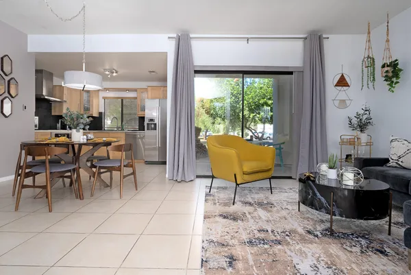 a living room with furniture a rug and a large window