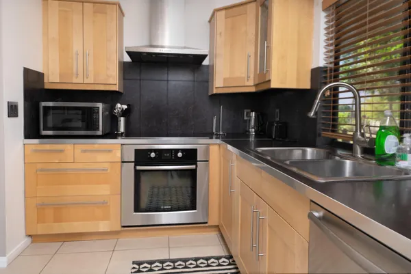a kitchen with granite countertop a stove and a sink