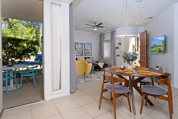 a view of a dining room with furniture and a potted plant