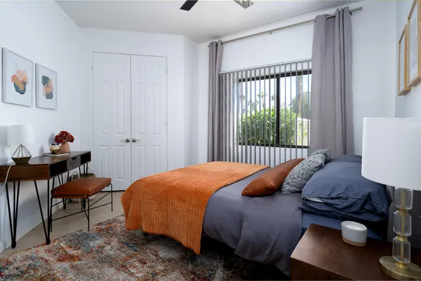 a bedroom with a bed and a window