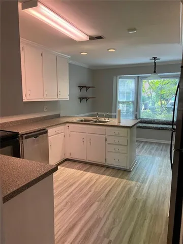 a kitchen with wooden floors and sink