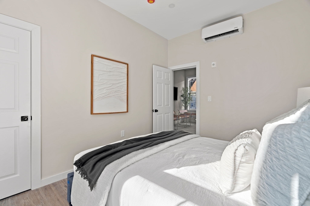 28 Hansborough Street, Unit FIVE Boston, MA 02124 - Photo 13 of 24 a bedroom with bed and a window