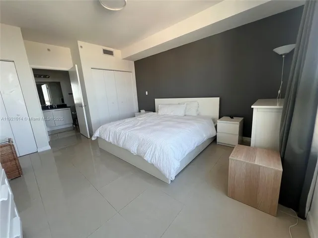 a bedroom with a bed and a couch