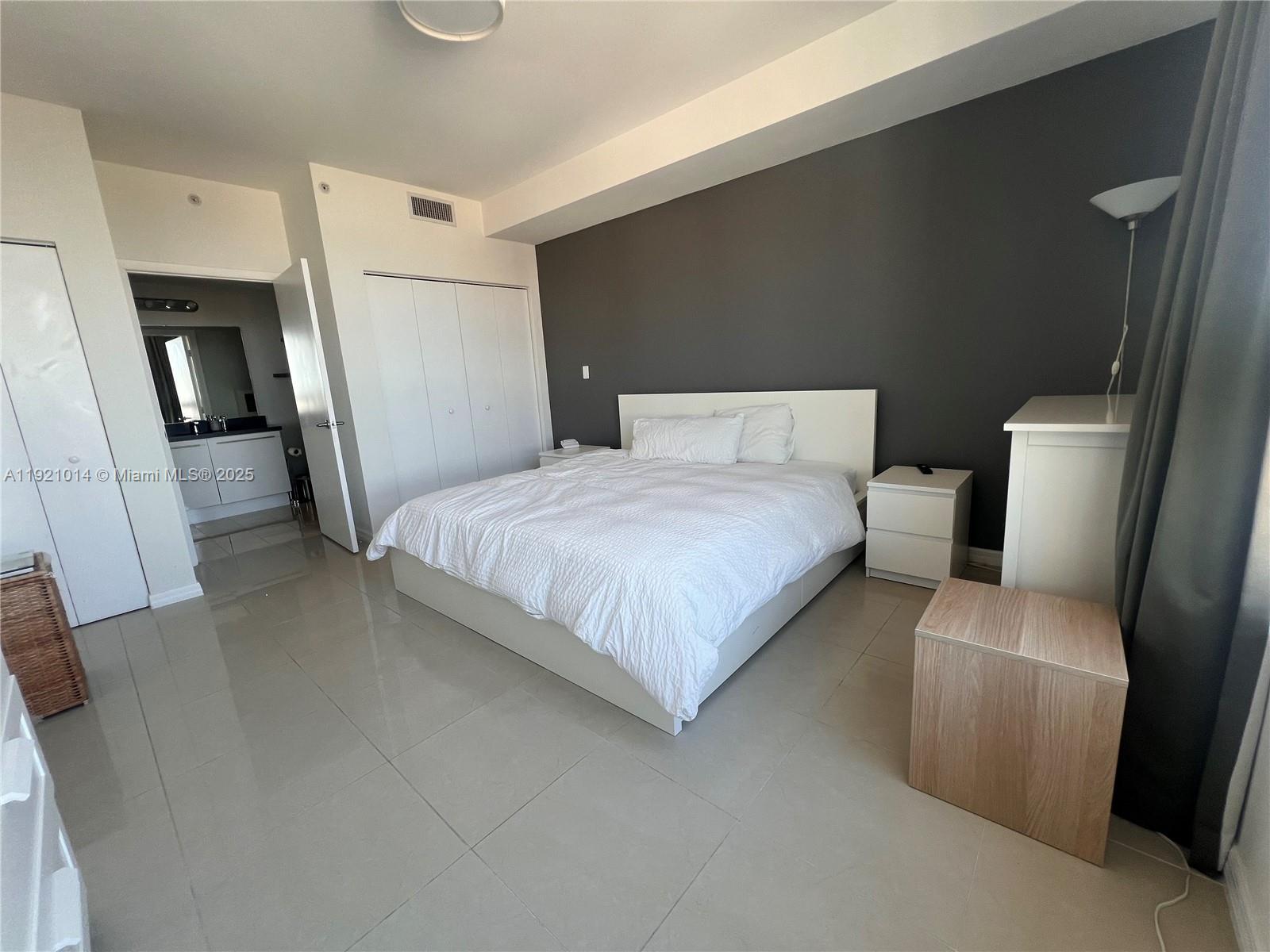 90 Southwest 3rd Street, Unit 2605 Miami, FL 33130 - Photo 6 of 15 a bedroom with a bed and a couch