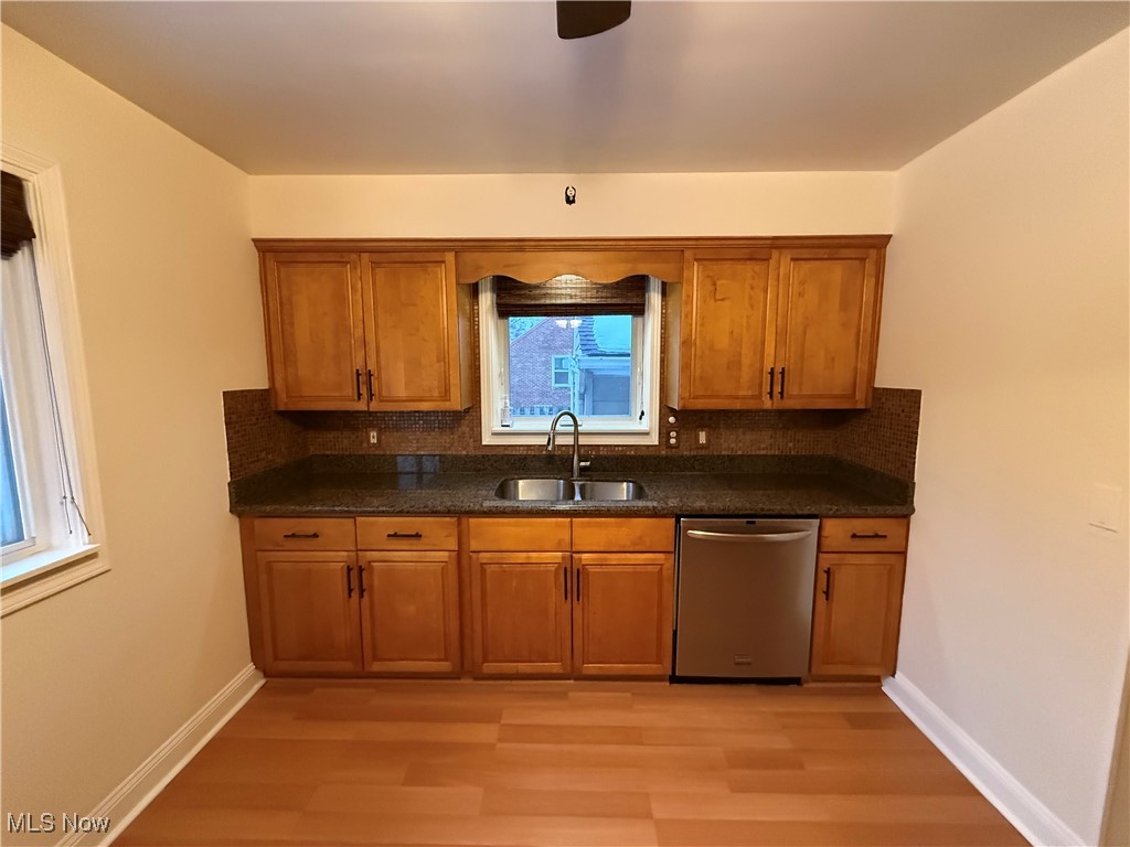 6290 Crossview Road Independence, OH 44131 - Photo 7 of 24 Kitchen with dishwasher, sink, decorative backsplash, and light wood-type flooring