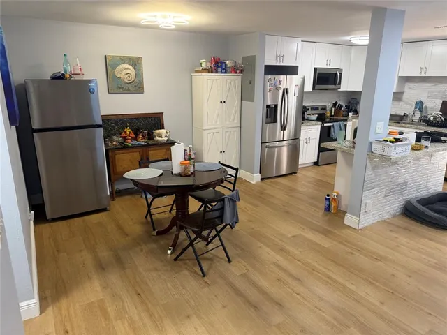 a kitchen with stainless steel appliances refrigerator stove microwave and cabinets