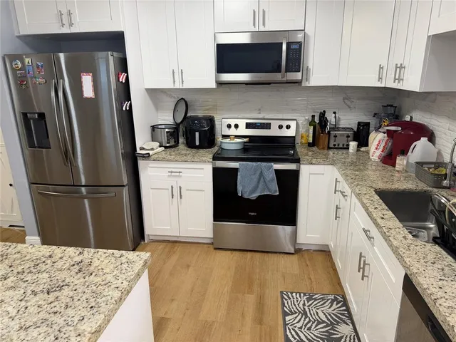 a kitchen with a sink appliances and cabinets