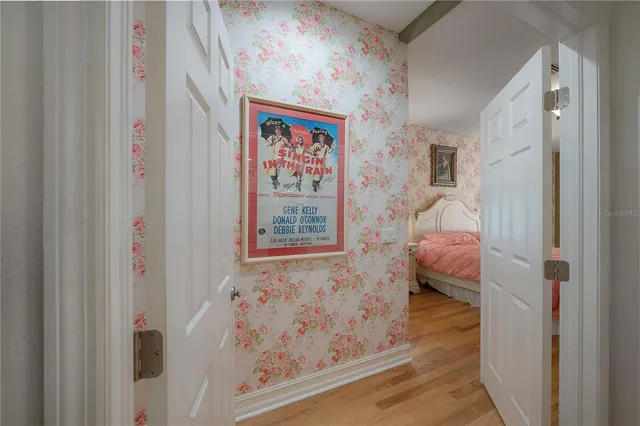 a spacious bedroom with a bed and a chandelier