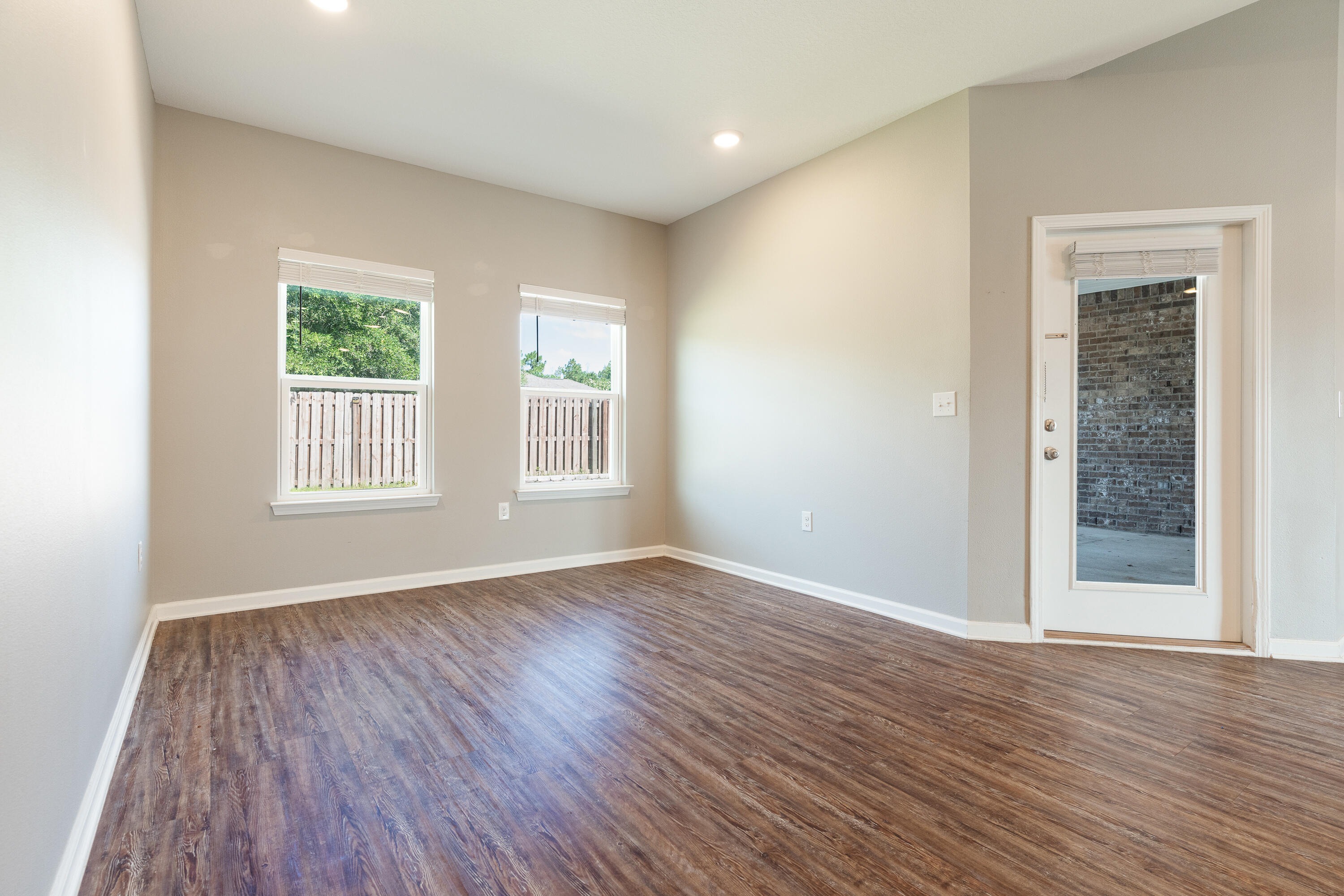 303 Merlin Court Crestview, FL 32539 - Photo 18 of 54 a view of an empty room with wooden floor and a window