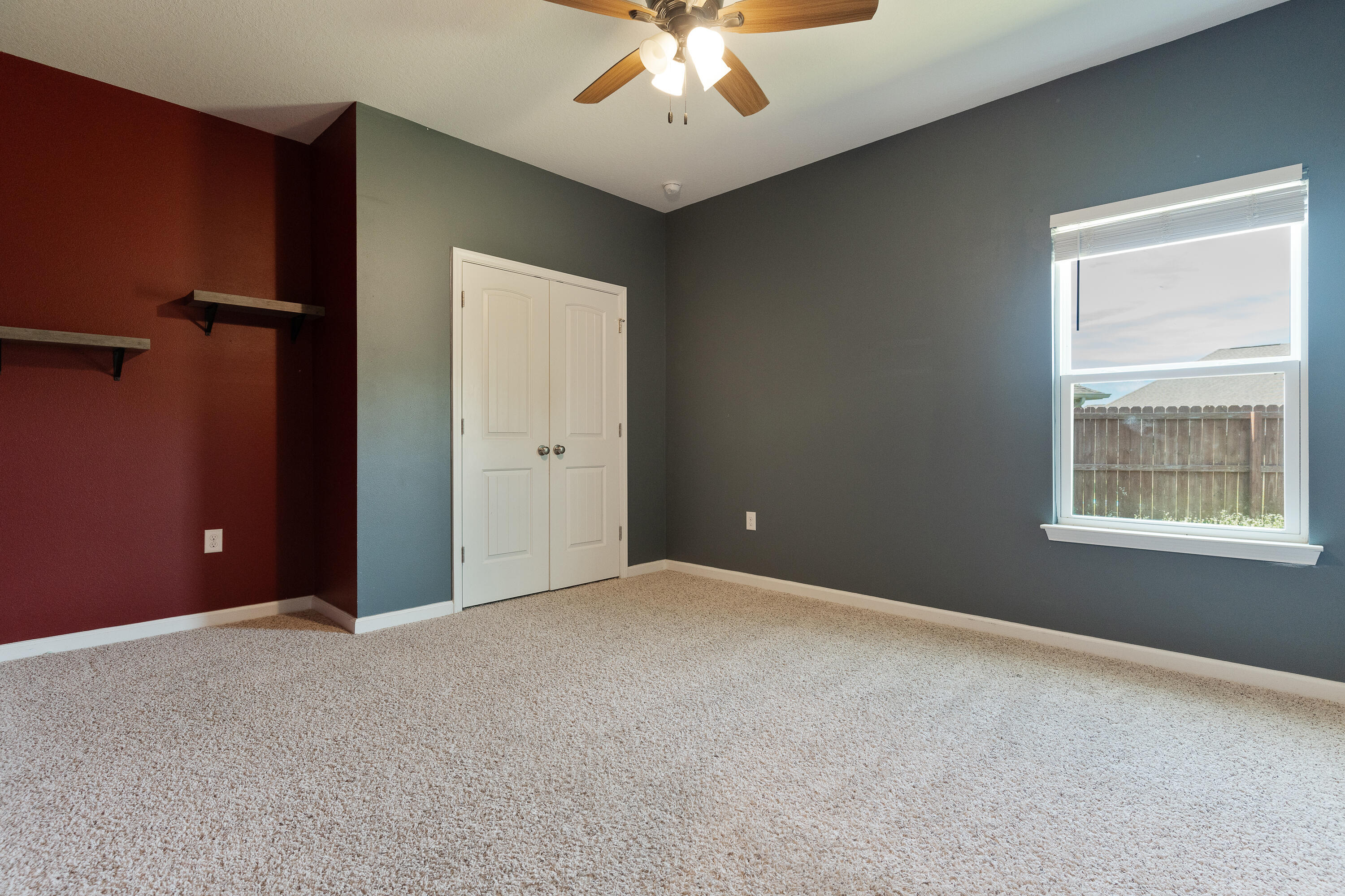 303 Merlin Court Crestview, FL 32539 - Photo 33 of 54 an empty room with windows and chandelier fan