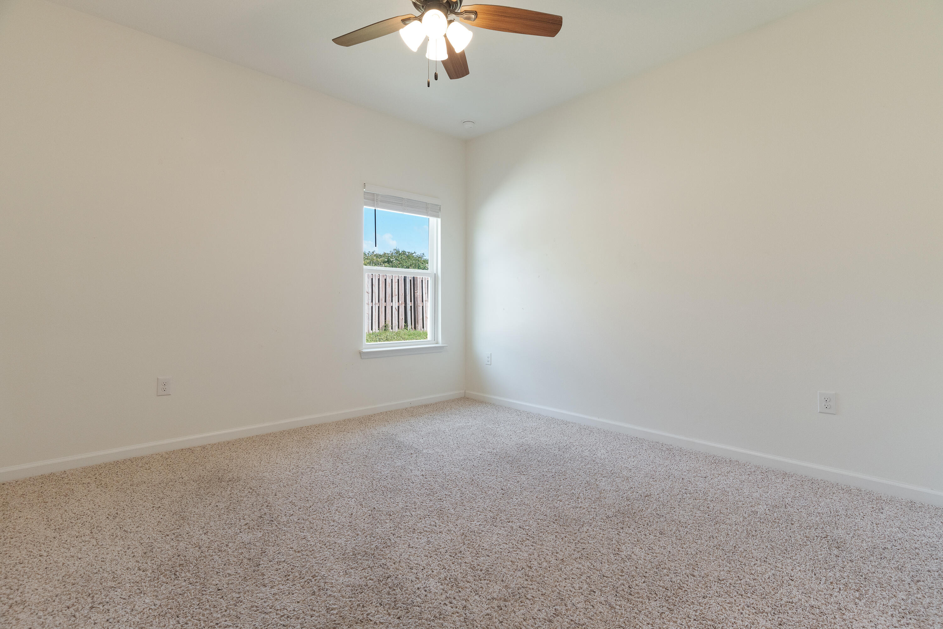 303 Merlin Court Crestview, FL 32539 - Photo 36 of 54 an empty room with a chandelier fan and windows