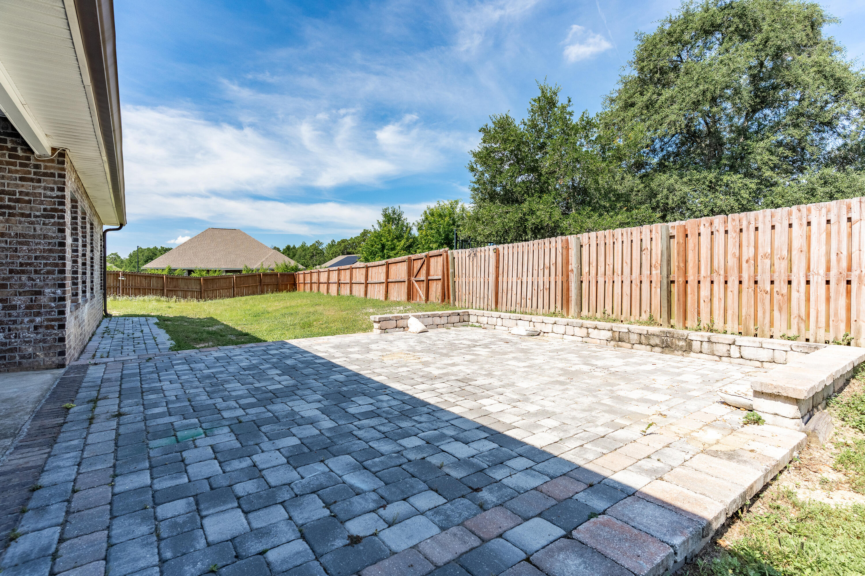 303 Merlin Court Crestview, FL 32539 - Photo 48 of 54 a view of swimming pool with lawn chairs and wooden fence