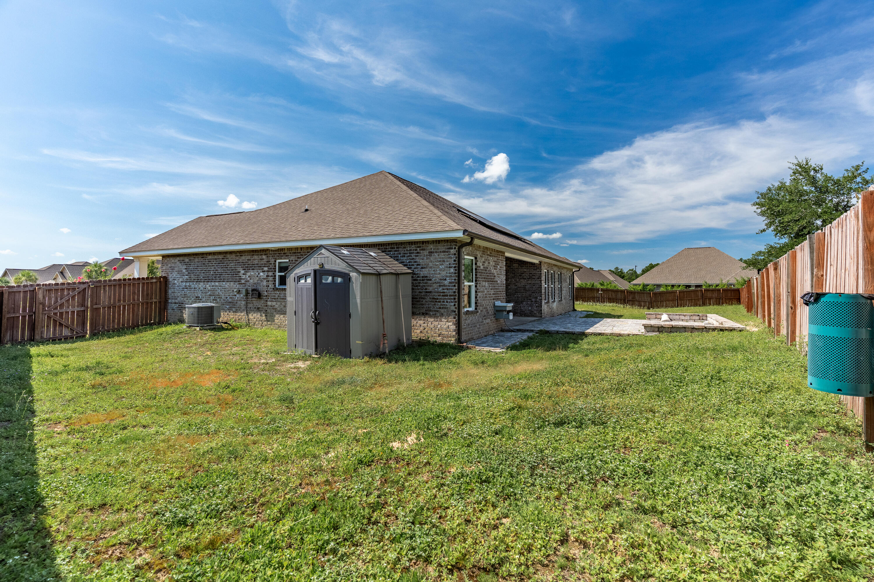 303 Merlin Court Crestview, FL 32539 - Photo 50 of 54 a backyard of a house with plants and wooden fence