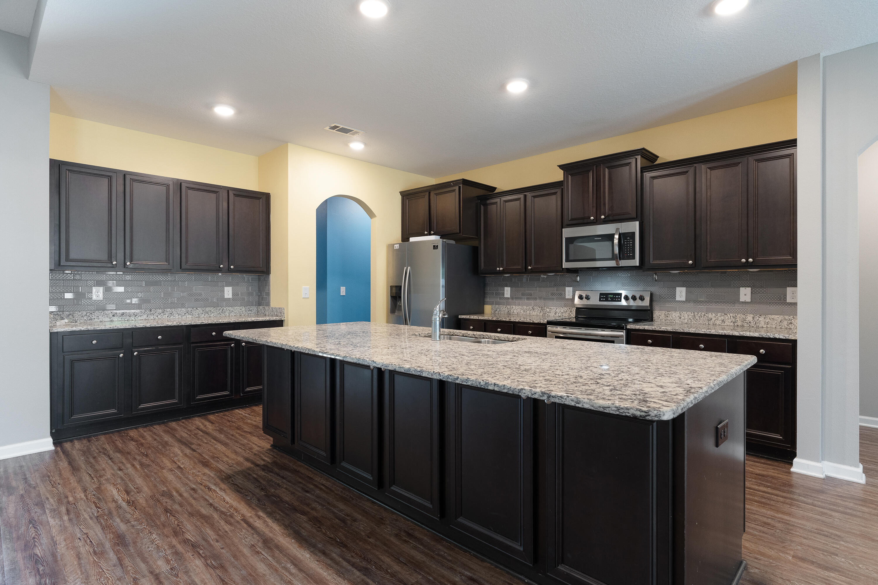 303 Merlin Court Crestview, FL 32539 - Photo 10 of 54 a kitchen with stainless steel appliances granite countertop wooden cabinets a stove top oven a sink and dishwasher