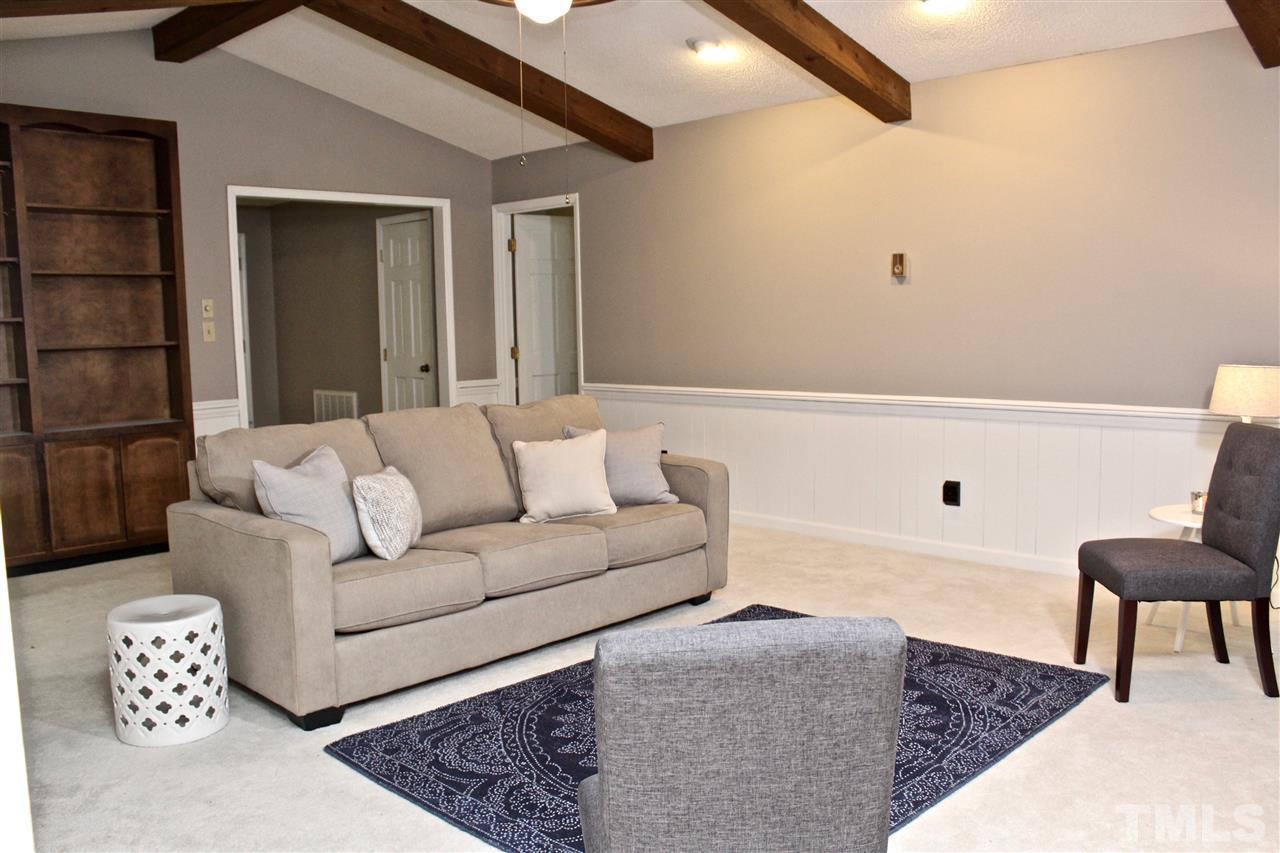 9444 Springdale Drive Raleigh, NC 27613 - Photo 2 of 25 a living room with furniture and a rug