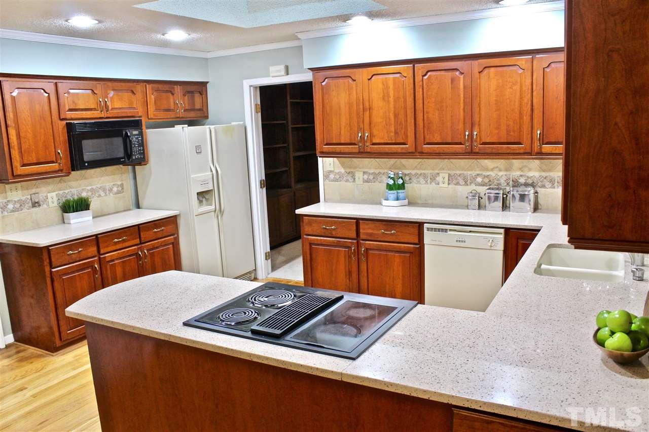 9444 Springdale Drive Raleigh, NC 27613 - Photo 14 of 25 a kitchen with a sink stove and refrigerator