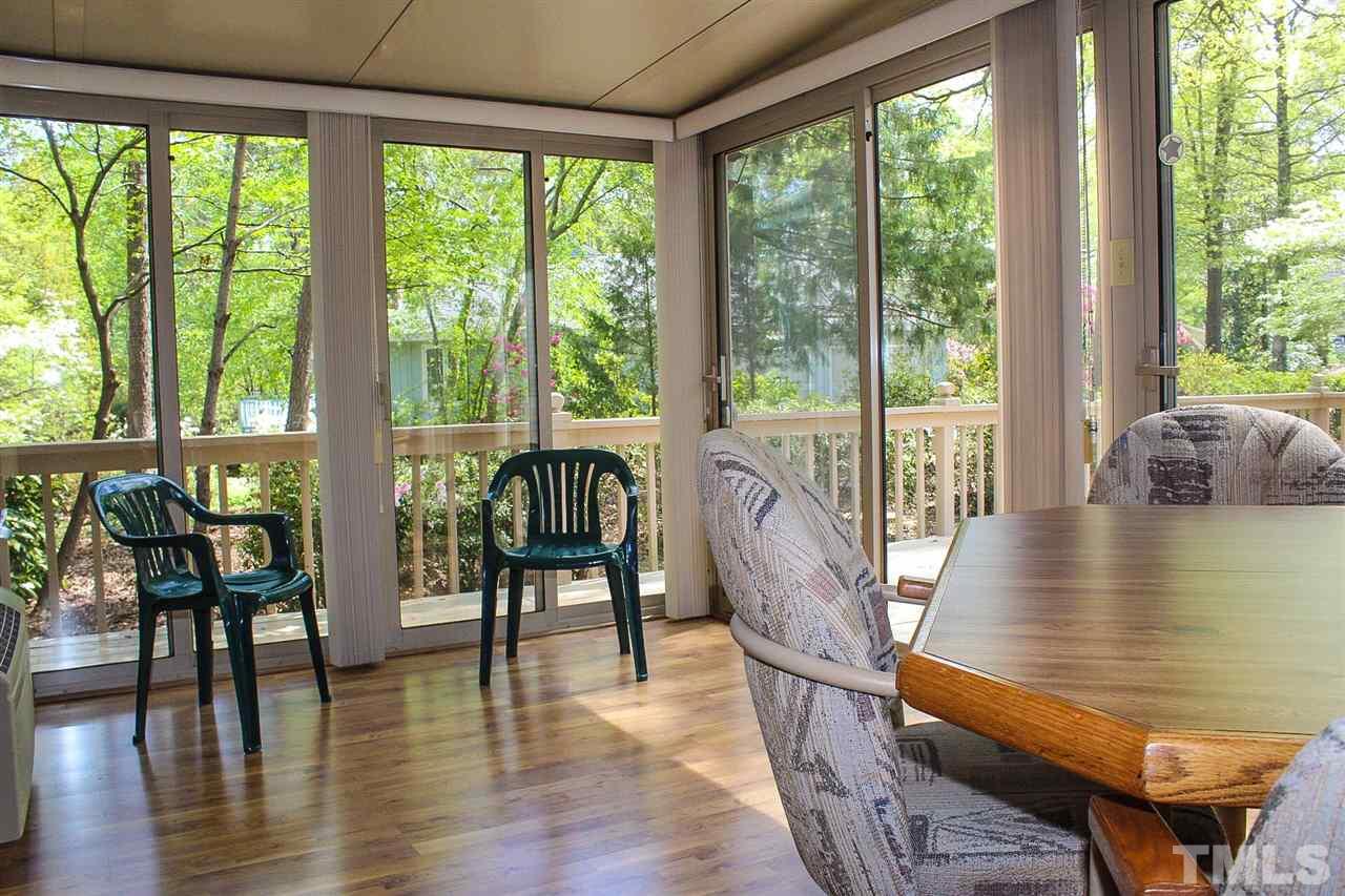 9444 Springdale Drive Raleigh, NC 27613 - Photo 16 of 25 a view of a dining room with furniture window and wooden floor