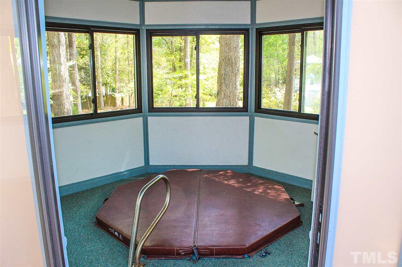 9444 Springdale Drive Raleigh, NC 27613 - Photo 18 of 25 a bed room with a bed and a window