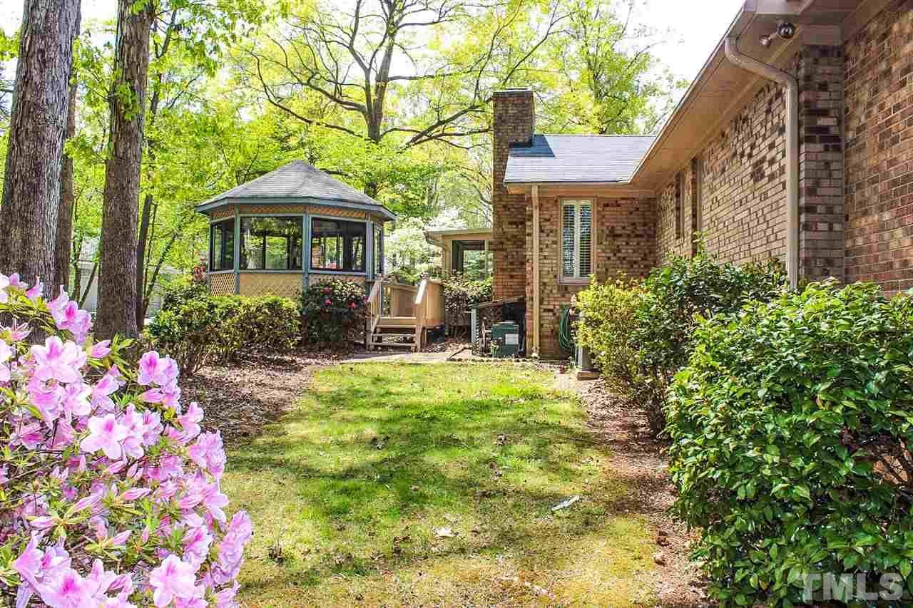 9444 Springdale Drive Raleigh, NC 27613 - Photo 19 of 25 a front view of a house with garden