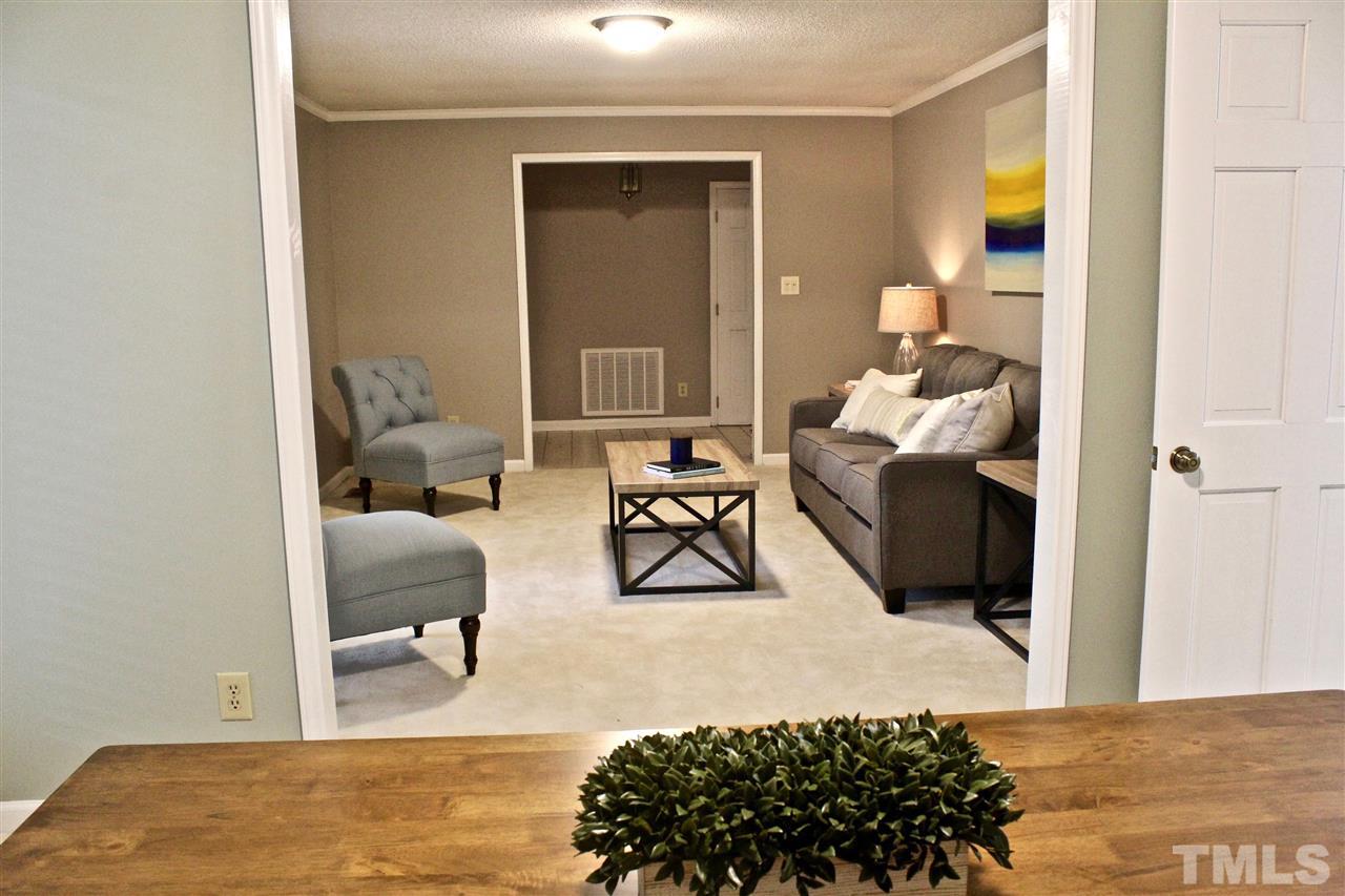 9444 Springdale Drive Raleigh, NC 27613 - Photo 20 of 25 a bedroom with bed and a couch