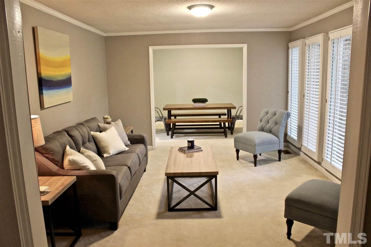 9444 Springdale Drive Raleigh, NC 27613 - Photo 21 of 25 a living room with furniture and a window