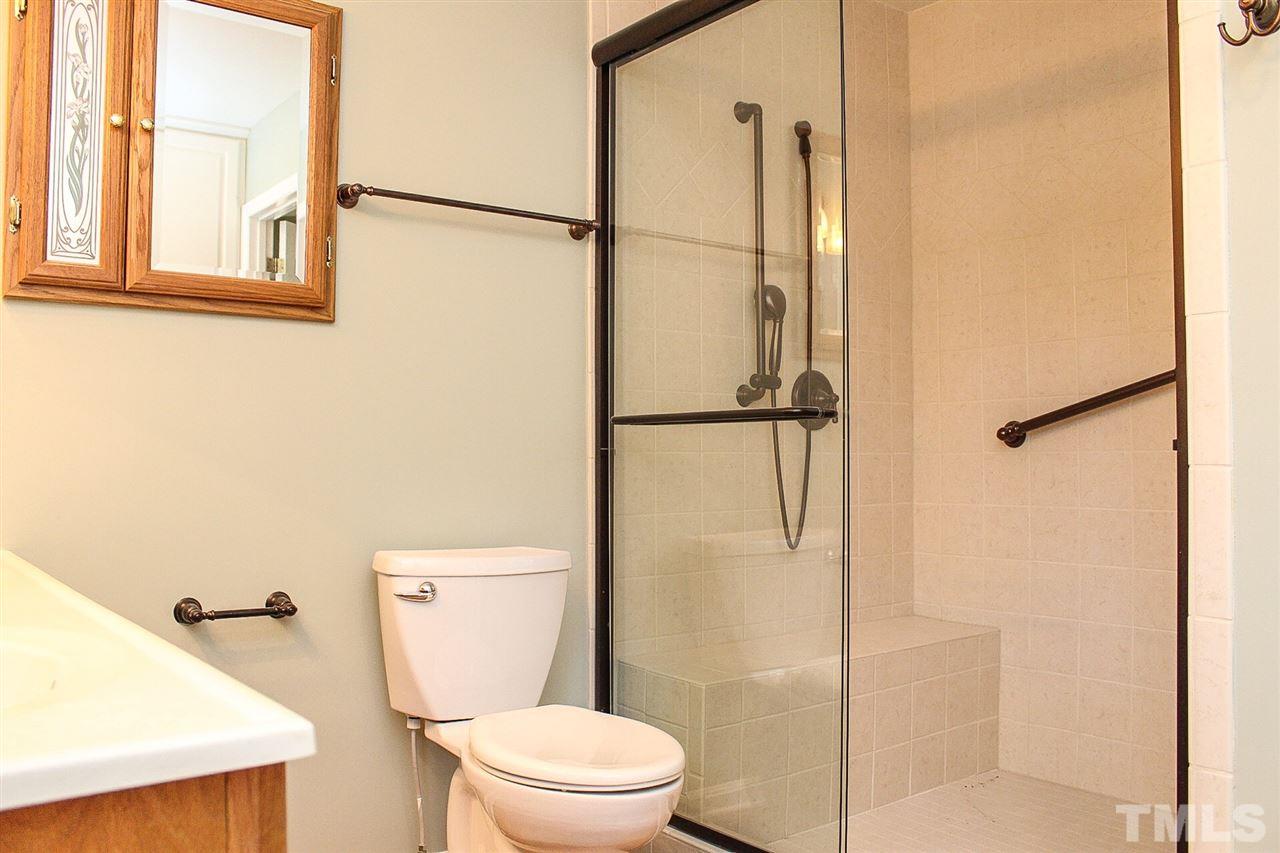 9444 Springdale Drive Raleigh, NC 27613 - Photo 22 of 25 a white toilet sitting next to a bathroom sink