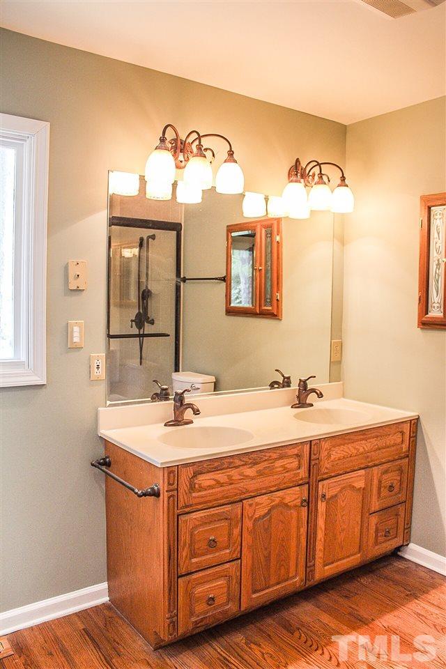 9444 Springdale Drive Raleigh, NC 27613 - Photo 23 of 25 a bathroom with a sink and a mirror