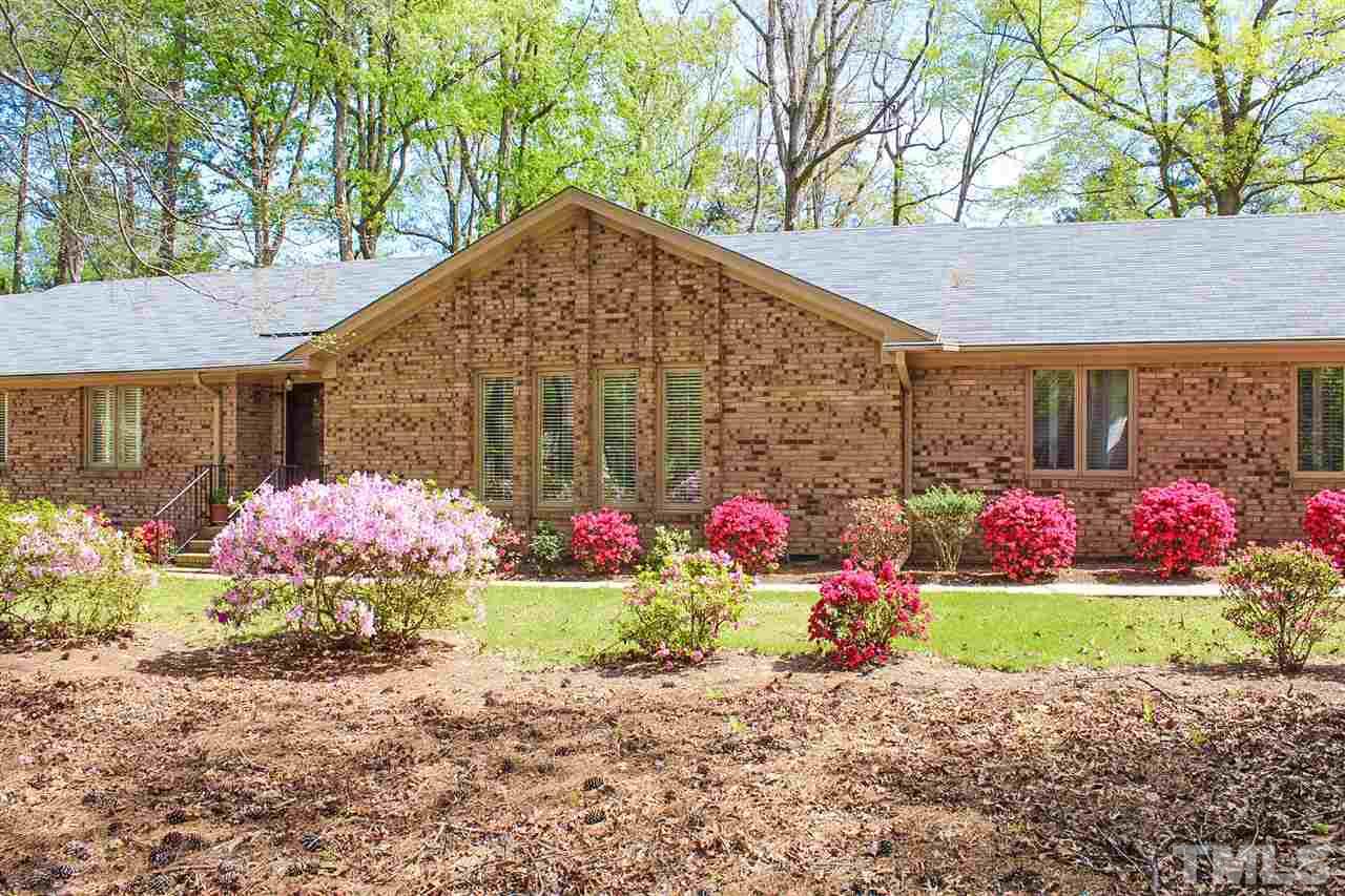 9444 Springdale Drive Raleigh, NC 27613 - Photo 24 of 25 a front view of a house with a yard and garage