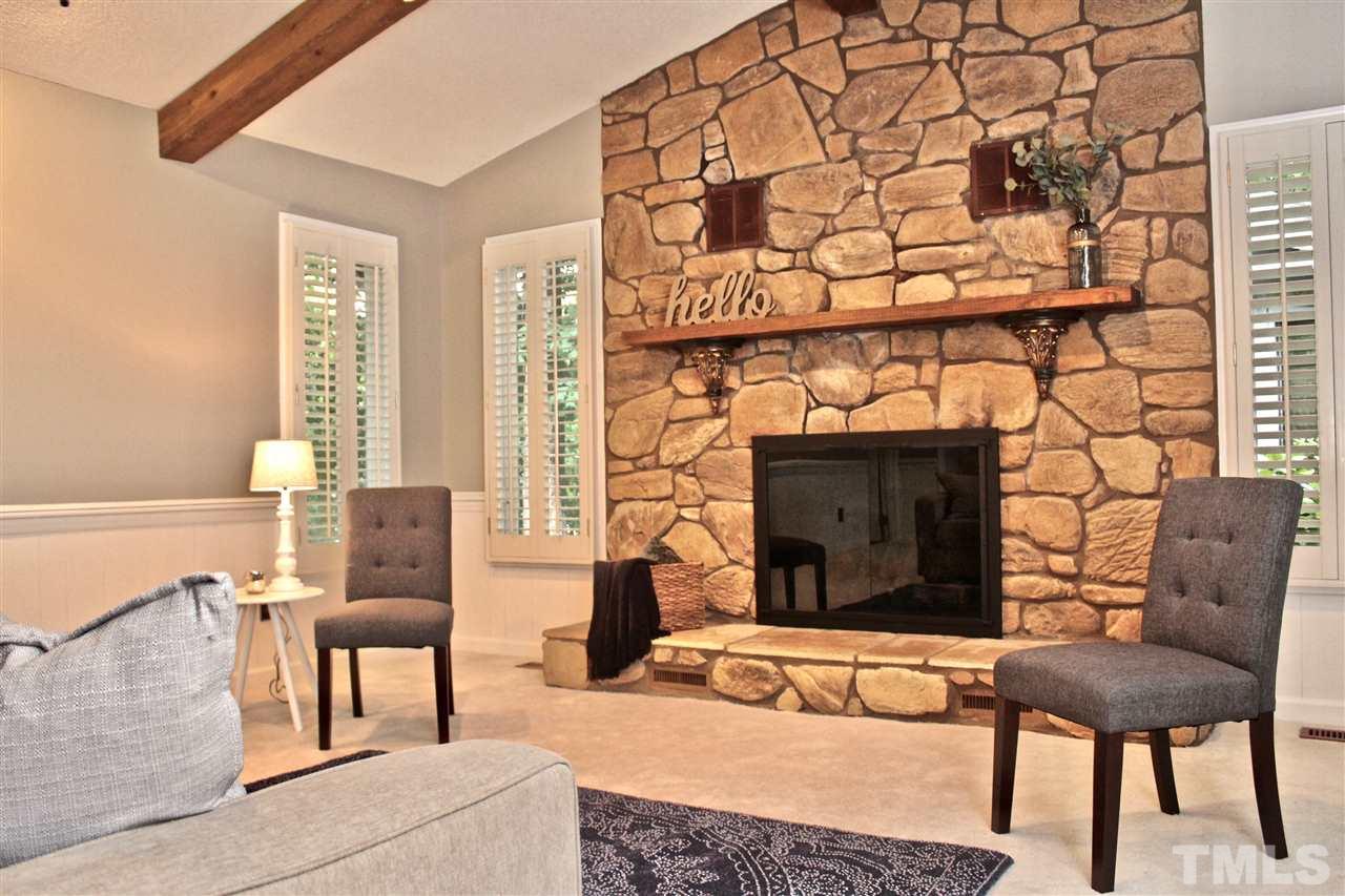 9444 Springdale Drive Raleigh, NC 27613 - Photo 4 of 25 a living room with furniture and a fireplace