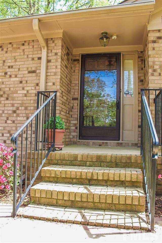 9444 Springdale Drive Raleigh, NC 27613 - Photo 10 of 25 a view of a entryway door front of house