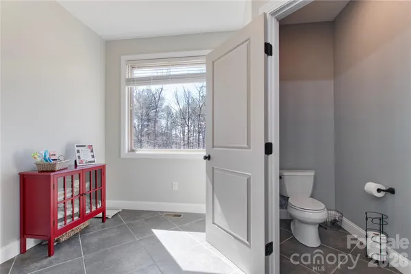a bathroom with a toilet tub and shower
