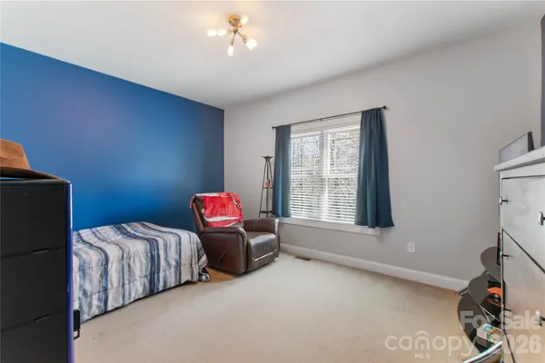 a bedroom with bed and window