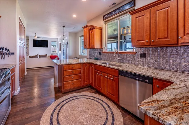 a kitchen with stainless steel appliances granite countertop a sink stove and cabinets