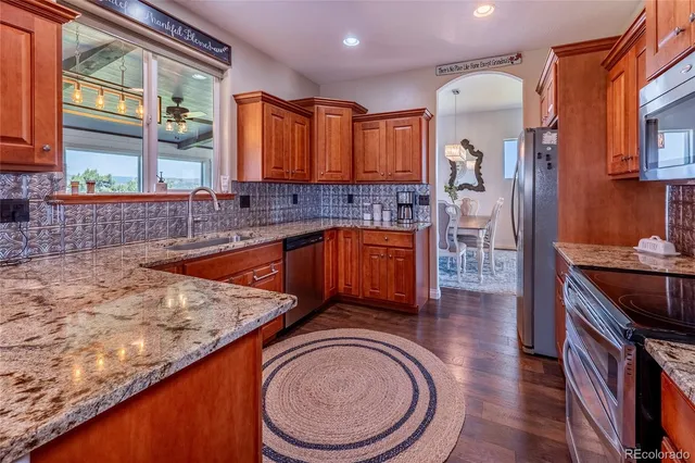 a bathroom with a granite countertop sink and a washing machine