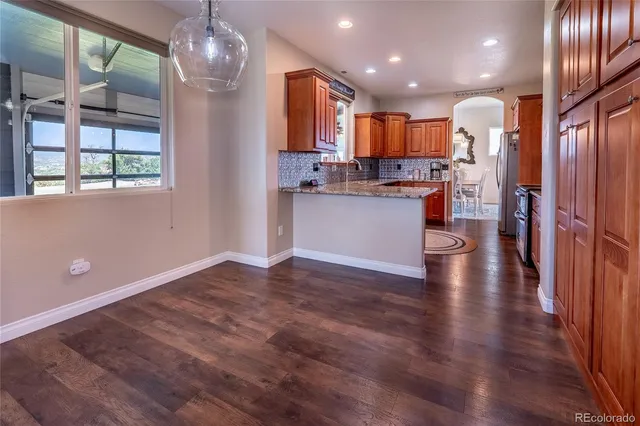 a kitchen with a refrigerator and microwave