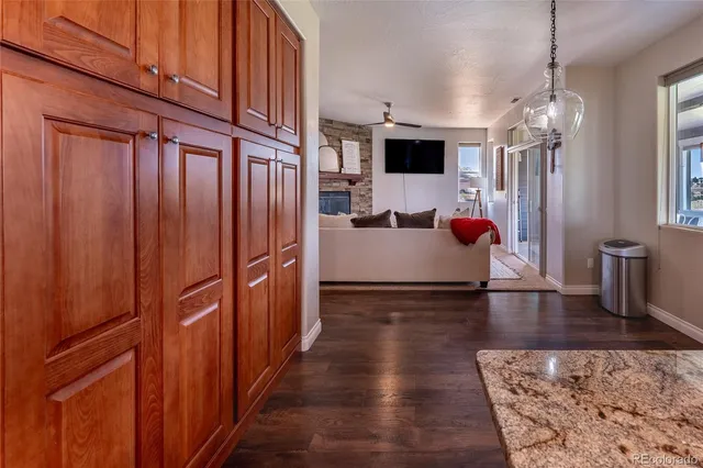 a view of a kitchen with flat screen tv wooden floor and a window