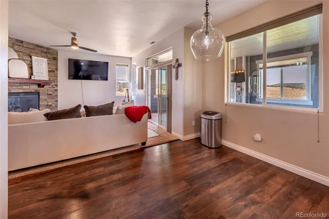 a kitchen with stainless steel appliances granite countertop a sink dishwasher and a flat screen tv