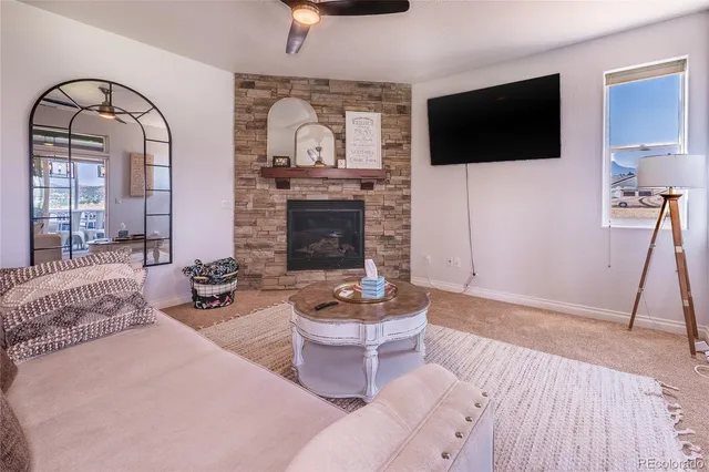 a living room with furniture a flat screen tv and a fireplace