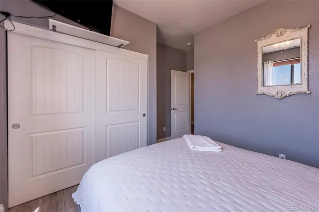 a bedroom with a bed and a mirror