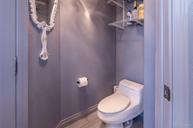 a white toilet sitting next to a shower