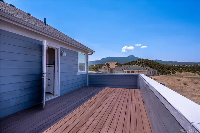 a view of a terrace with wooden floor and cabinet