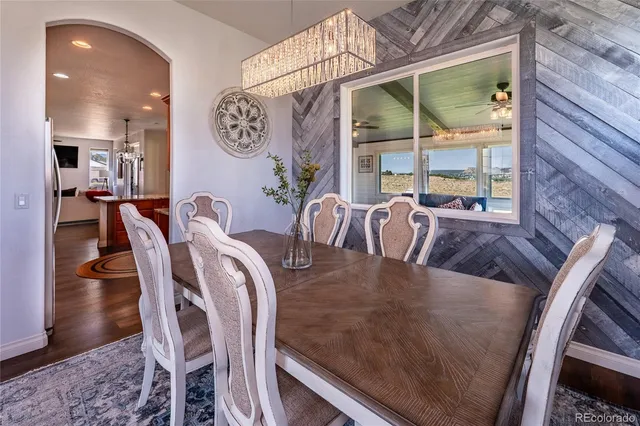 a view of a dining room with furniture wooden floor and a chandelier