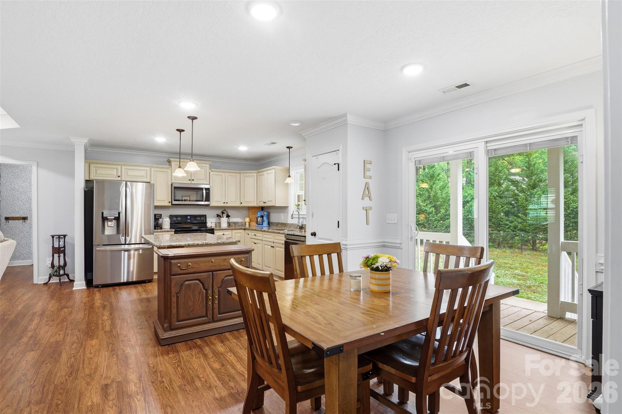 810 Tirzah Road York, SC 29745 - Photo 7 of 29 a kitchen with stainless steel appliances granite countertop a stove a refrigerator a kitchen island stools a stove a dining table and chairs