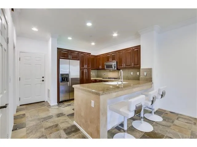 a kitchen with stainless steel appliances granite countertop a sink and cabinets