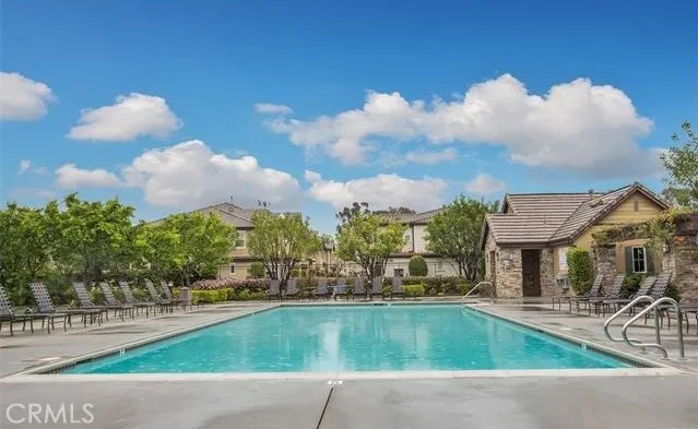 a view of a house with swimming pool and sitting area