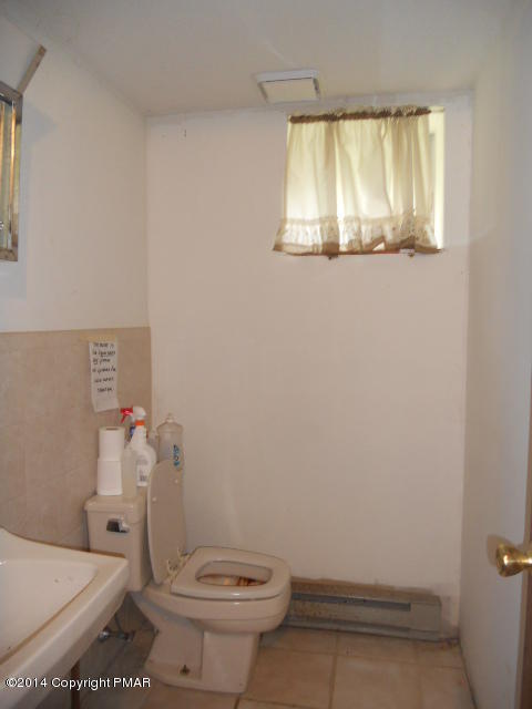 3 Edgewood Road Mount Pocono, PA 18344 - Photo 14 of 23 a white toilet sitting next to a bathroom sink and vanity