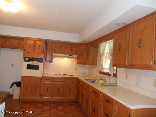 3 Edgewood Road Mount Pocono, PA 18344 - Photo 4 of 23 a kitchen with a sink a stove cabinets and a window